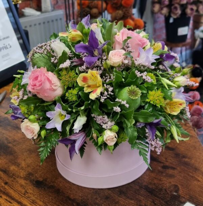 The wild one - A stunning selection of pink yellow and purple blooms arranged loving in a hatbox would make this the perfect gift